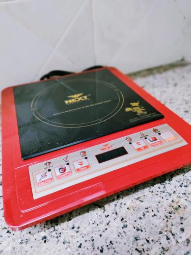 a red device sitting on top of a table at Entire Studio Apt/Suite near Mall/Metro/ExpoMart in Noida