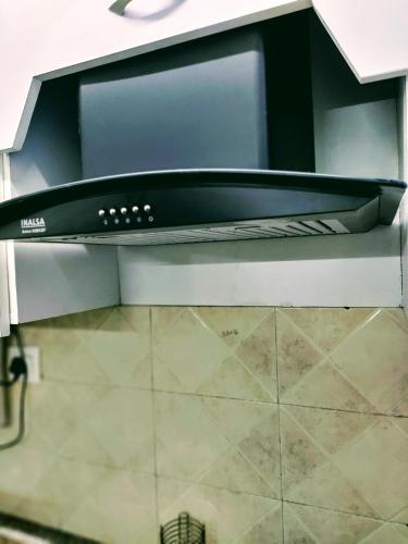 a stove top oven in a kitchen at Entire Studio Apt/Suite near Mall/Metro/ExpoMart in Noida