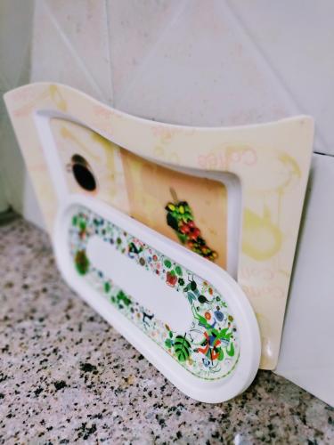 a toilet seat with a picture of a butterfly on it at Entire Studio Apt/Suite near Mall/Metro/ExpoMart in Noida