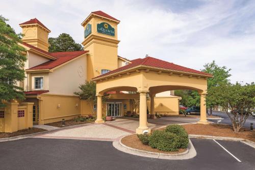 a building with a clock tower on top of it at La Quinta Inn & Suites by Wyndham University Area Chapel Hill in Durham