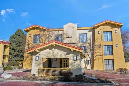 a yellow building with a gate in front of it at La Quinta Inn by Wyndham Denver Golden in Golden