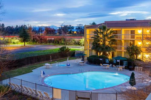 a swimming pool in front of a hotel at La Quinta by Wyndham Redding in Redding