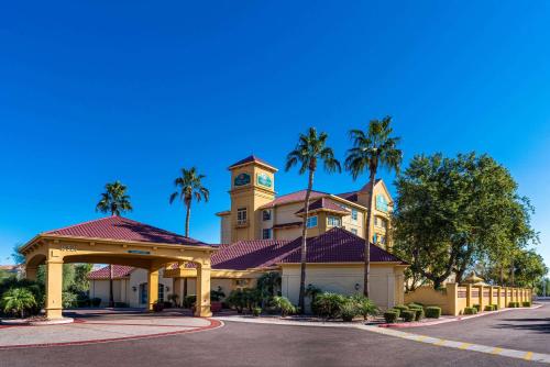 a building with a clock tower and palm trees at La Quinta by Wyndham Phoenix West Peoria in Peoria