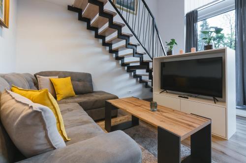 a living room with a couch and a television at Vila Rina in Bled