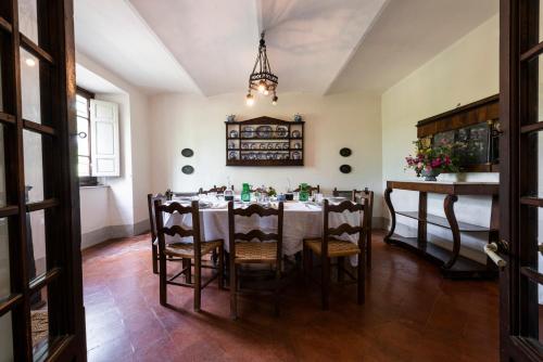 a dining room with a table and chairs at Villa Poggio Cherici by Mmega in Rignano sullʼArno