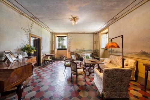a living room with a couch and a table and chairs at Villa Poggio Cherici by Mmega in Rignano sullʼArno