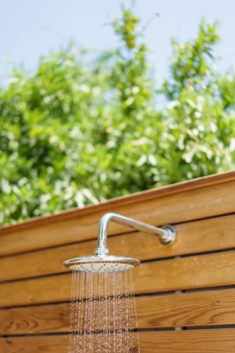a shower head hanging on a wooden fence at Costa Maya Bodrum in Bodrum City