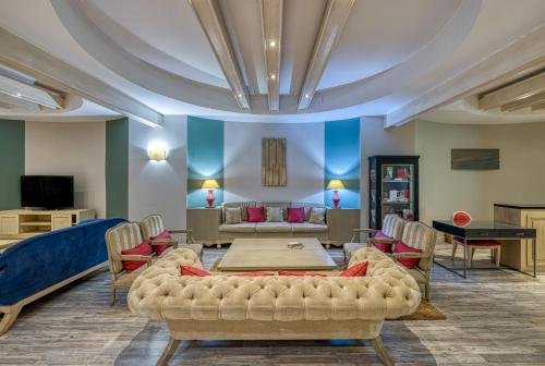 a living room with a couch and a table and chairs at Virgen de los Reyes in Seville