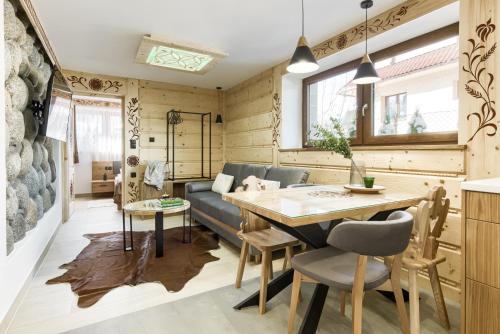Rezydencja Śpiący Rycerz في زاكوباني: غرفة معيشة مع طاولة وأريكة
