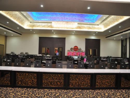 a large conference room with chairs and a stage at Hotel Sepal in Bathinda