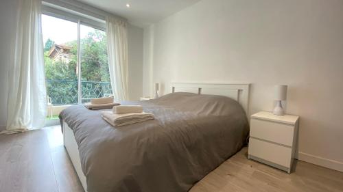 une chambre avec un grand lit avec une fenêtre dans l'établissement Vilmorin Appartement 1 Chambre proche de gare, plage, centre, à Antibes