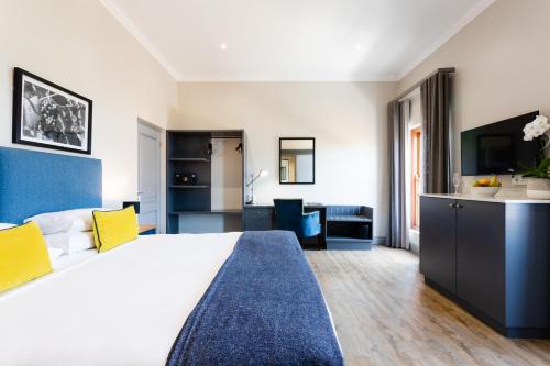 a hotel room with a large bed and a desk at De Zalze Lodge in Stellenbosch