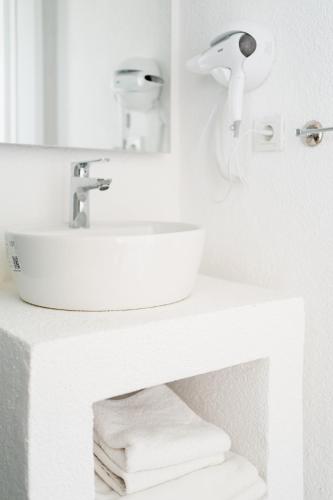a white bathroom with a sink and a mirror at Costa Sariyaz Hotel Bodrum in Bodrum City