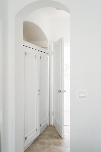 a room with white walls and a white door at Costa Sariyaz Hotel Bodrum in Bodrum City