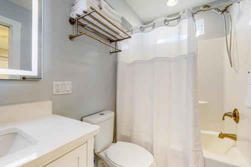a bathroom with a toilet and a sink and a shower at Sweet Studio Suite in Rockport