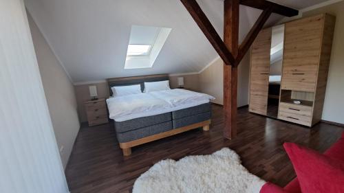 a bedroom with a king sized bed in a attic at Appartement Köck 110qm in Reisbach