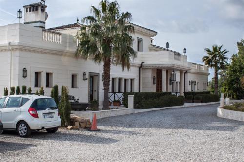 a white car parked in front of a building at Hotel Villarocamar in Mijas
