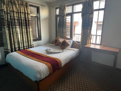 Кровать или кровати в номере Holy Land Hotel Nepal