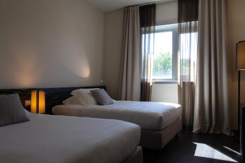 Postel nebo postele na pokoji v ubytování G Hotel Ancona