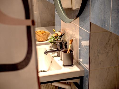 a bathroom with a sink and a mirror at Artini Apartments Piran in Piran
