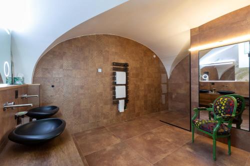 a bathroom with two chairs and a mirror at Romantik Hotel le Vignier in Avry devant Pont