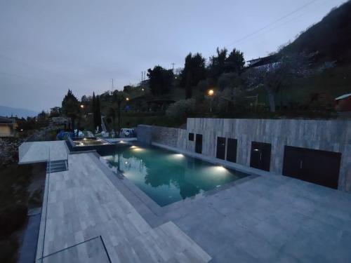 a swimming pool in the middle of a house at night at Village Hotel Lucia in Tremosine Sul Garda