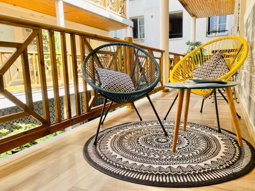 two chairs sitting on a balcony with a rug at Hôtel Clairefontaine in Paris
