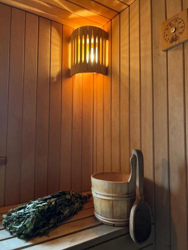 a sauna with a wooden barrel and a light at Stella in Ziemupe