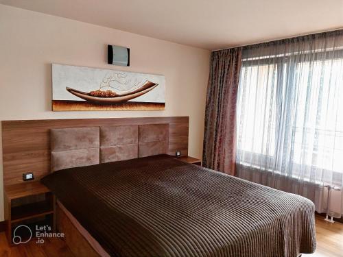 Un pat sau paturi într-o cameră la Къща Наковски