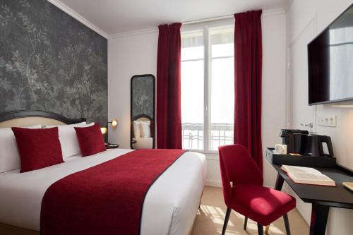 a hotel room with a bed and a desk and a window at Hotel Villa Romantic & Spa in Paris