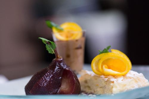 a piece of food on a plate with a piece of fruit at Grand Hotel Continental Bucuresti in Bucharest