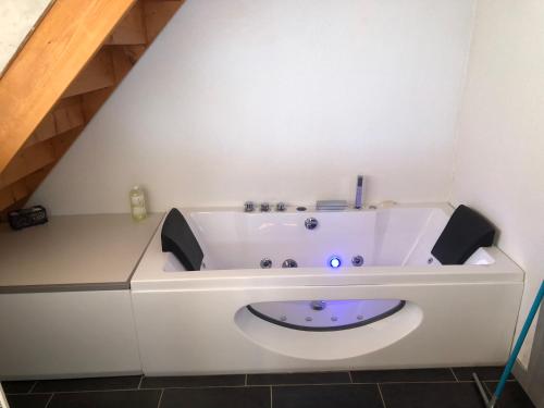 a white bath tub with a purple floor in a bathroom at La maison bleue in Altenbach