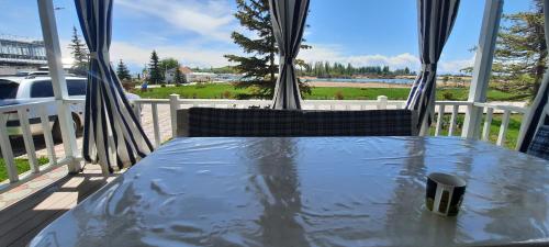 a table on a porch with a view of the water at Уютный коттедж на берегу Иссык-Куля, Киргизия in Chok-Tal