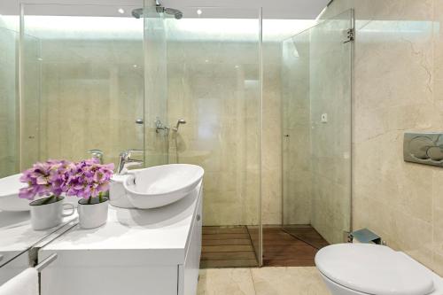 a bathroom with a toilet and a sink and a shower at Own Places - Ocean View Apartment in Matosinhos