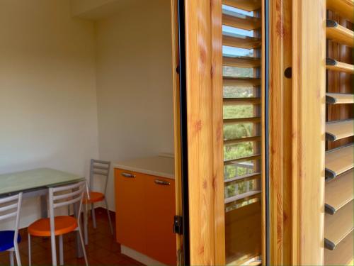 a door to a wine cellar with a table at Casa Uliveto in Mattinata