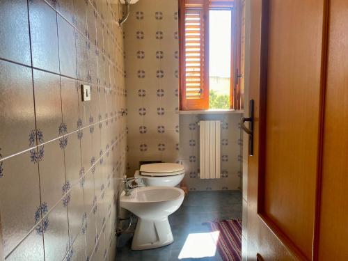 a bathroom with a toilet and a sink at Casa Uliveto in Mattinata
