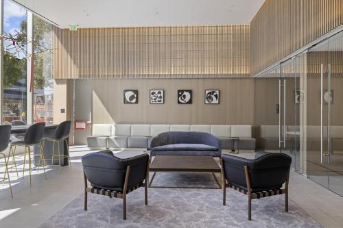 a lobby with a couch and chairs and a table at WhyHotel by Placemakr, San Jose in San Jose