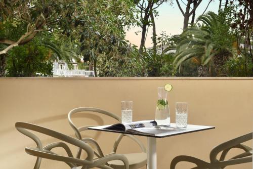a table with two chairs and a ball on top of it at Park Hotel Marinetta - Beach & Spa in Marina di Bibbona