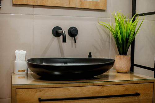 a black bowl sink on a counter in a bathroom at Ideal House in Parga