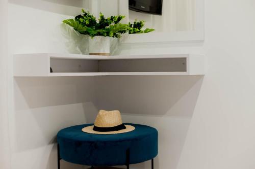 a hat sitting on top of a blue stool at Ideal House in Parga