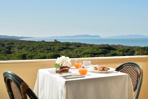 a table with food and drinks on top of a balcony at Park Hotel Marinetta - Beach & Spa in Marina di Bibbona
