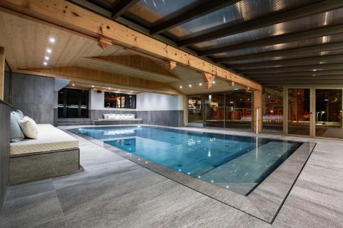 a large swimming pool in a house at Hôtel Névé in Morzine