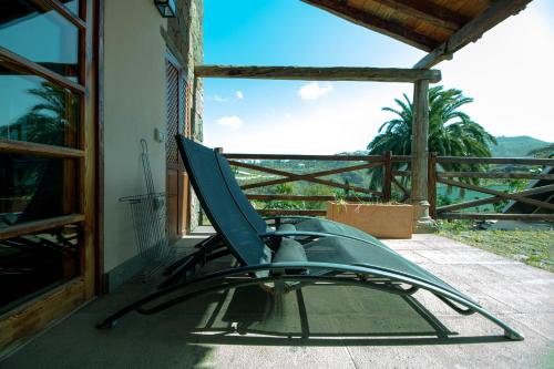 a chair sitting on the porch of a house at Mountain Hideaway House in Moya in Moya