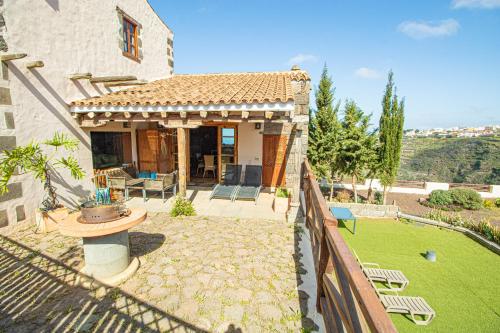 a house with a fence and a yard at Mountain Hideaway House in Moya in Moya