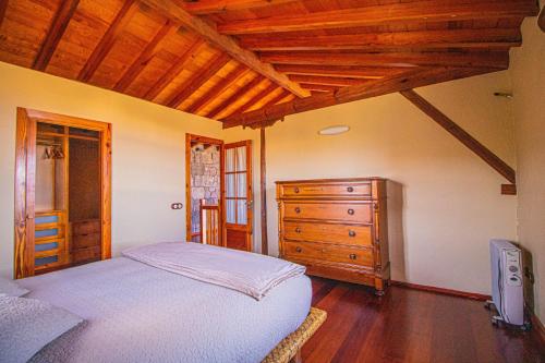 a bedroom with a bed and a wooden dresser at Mountain Hideaway House in Moya in Moya