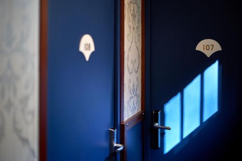 a blue door with the number on it at Hotel Villa Romantic & Spa in Paris
