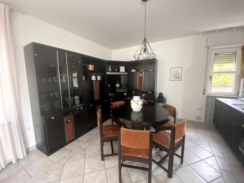 a kitchen with a dining room table and chairs at Terra del Sasso Country-house in Sasso di Castalda