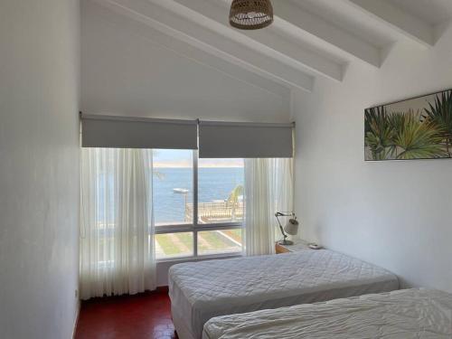 A bed or beds in a room at Beachfront, 4BR, entire house in Paracas