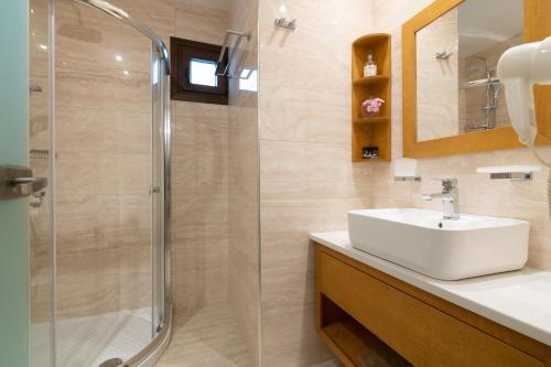 a bathroom with a sink and a shower at Zante Holidays Hotel in Kalamaki
