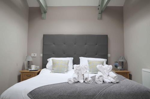 a bedroom with a bed with towels on it at Chiff Chaff in Belford
